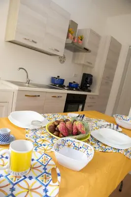 a table with a bowl of fruit on it at Casa Vacanze Ines in Carini