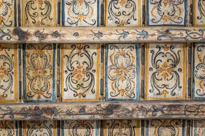 an old wooden wall with ornate patterns on it at Quattro Canti rooms in Palermo