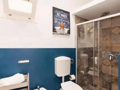 a bathroom with a toilet and a shower at Casa di DaFe-Casa Vacanze in Castellammare del Golfo