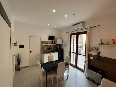 a kitchen and dining room with a table and chairs at Casa di DaFe-Casa Vacanze in Castellammare del Golfo