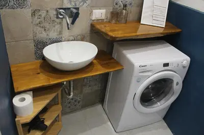 a bathroom with a washing machine and a sink at Casa di DaFe-Casa Vacanze in Castellammare del Golfo