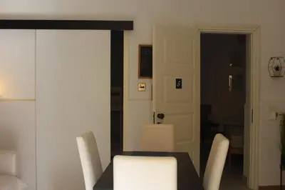 a dining room with a table and white chairs at Casa di DaFe-Casa Vacanze in Castellammare del Golfo