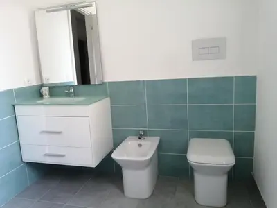 a bathroom with a toilet and a sink and a mirror at Studio Florio in Palermo