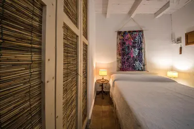 a bedroom with a bed and a window at Casa Strelizie in Terrasini