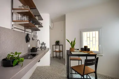 a kitchen with a table and chairs in a room at Casa Design tra le Mura by Wonderful Italy in Palermo