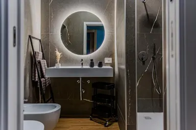 a bathroom with a sink and a mirror at Le Carte in Castellammare del Golfo