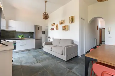 a kitchen and living room with a couch and a table at Villa Ammirata Mondello by Wonderful Italy in Mondello