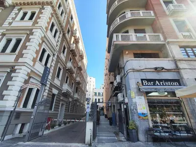 a street in a city with two tall buildings at Politeama guest house Palermo Pomelia in Palermo