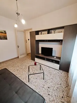 a living room with a large entertainment center with a flat screen tv at Costanza House in Palermo