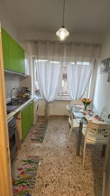 a kitchen with a table and a dining room at Costanza House in Palermo