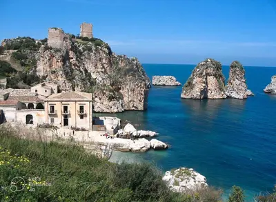 an old building on a rocky island in the water at Appartamento Matteo in Trappeto