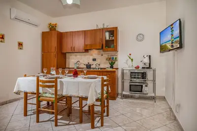 a kitchen with a table and chairs in a kitchen at Casa Dolce Casa in Castellammare del Golfo