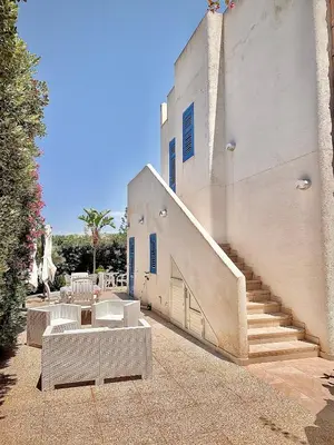 a white building with stairs and a stair case at Villa La Palmetta a San Vito lo capo in San Vito lo Capo