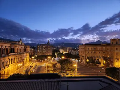 a view of a city at night at Mangano Suites in Palermo