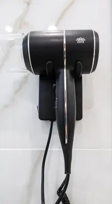 a black flashlight hanging on a wall at Mangano Suites in Palermo