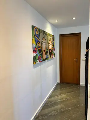 a painting hanging on a wall next to a door at A CASA DI GRACE in Palermo