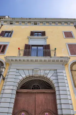 a building with a balcony over a door at Palazzo Sant'Isidoro by DomuSicily in Palermo