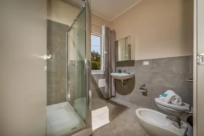 a bathroom with a shower and a sink and a toilet at Villa Spada con ampi spazi esterni in San Vito lo Capo