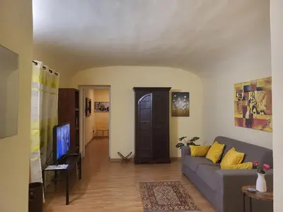 a living room with a couch and a tv at Casa Amarilla in Palermo