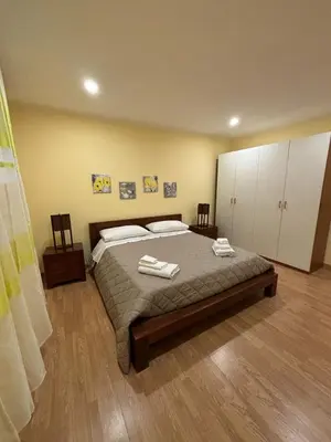 a bedroom with a bed with two towels on it at Casa Amarilla in Palermo