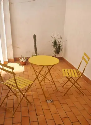 a yellow table and two chairs in a room at Casa Amarilla in Palermo
