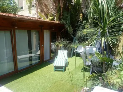 a patio with two chairs on the grass at Loft Mondello Beach in Palermo