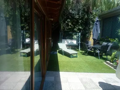 a reflection of a patio with chairs and a table at Loft Mondello Beach in Palermo