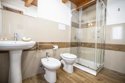 a bathroom with a sink and a toilet and a shower at Quattro Canti in Carini