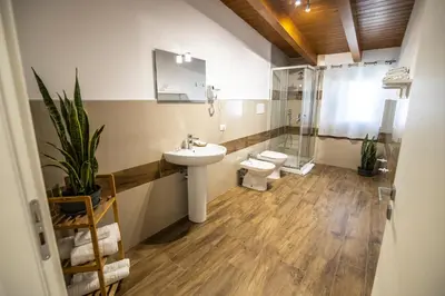 a bathroom with a sink and a toilet and a shower at Quattro Canti in Carini