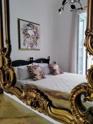 a bedroom with a bed with a gold frame at Domus Vetriera in Palermo