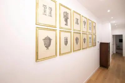 a wall with a bunch of pictures on a wall at Villareale47 Luxury Suites & Rooms in Palermo
