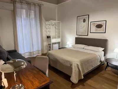 a bedroom with a bed and a living room at Villareale47 Luxury Suites & Rooms in Palermo