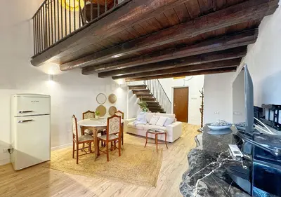 a kitchen and living room with a table and chairs at Solemar Sicilia - Casa Enrica in Palermo