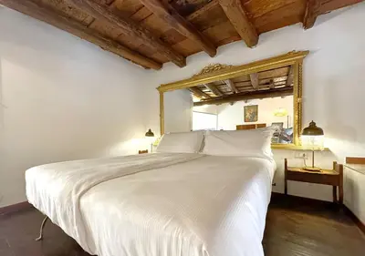 a bedroom with a white bed and a mirror at Solemar Sicilia - Casa Enrica in Palermo