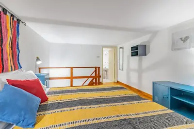 a bedroom with a bed and a tv on the wall at GuestHost - The Traveller's House - Palermo Station Apartments in Palermo