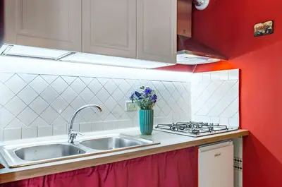 a kitchen with a sink and a stove at GuestHost - The Traveller's House - Palermo Station Apartments in Palermo