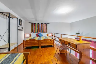 a bedroom with a bed and a desk in a room at GuestHost - The Traveller's House - Palermo Station Apartments in Palermo