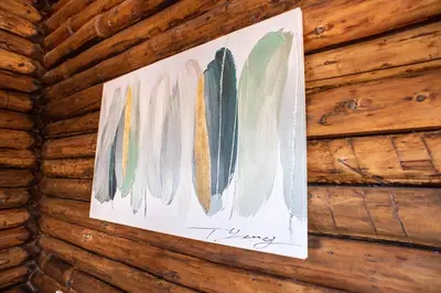 a painting hanging on a wooden wall at Chalet Seaview by AR Group Hotels in Isola delle Femmine