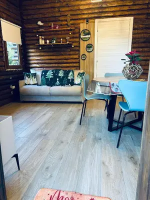 a living room with a couch and a table at Chalet Seaview by AR Group Hotels in Isola delle Femmine