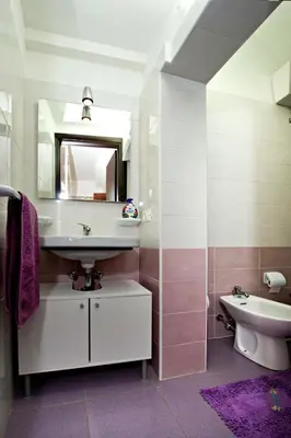 a bathroom with a sink and a mirror and a toilet at Casa Fugardi in Castellammare del Golfo