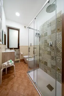 a bathroom with a glass shower and a toilet at Palermo e Dintorni - Valentino Apartment in Palermo
