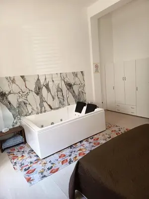 a white bath tub in a room with a rug at casa colombo in Balestrate