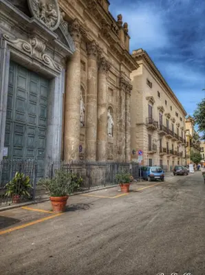 a large building with cars parked in front of it at BIBI rooms and suite in Palermo