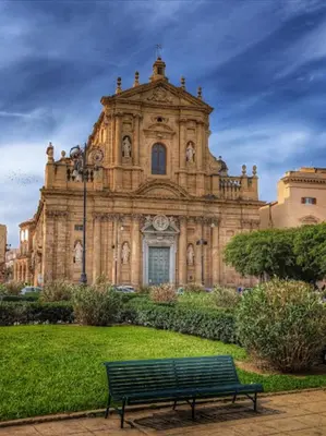 an old building with a bench in front of it at BIBI rooms and suite in Palermo