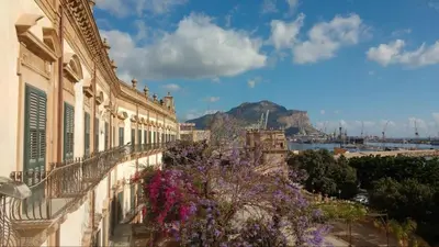 a balcony with flowers on the side of a building at BIBI rooms and suite in Palermo