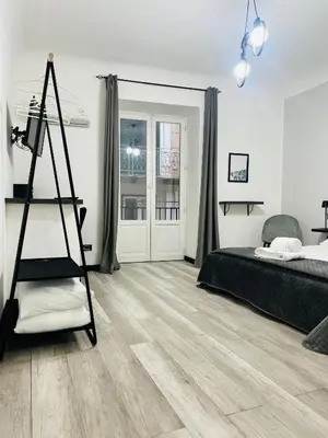 a bedroom with a bed and a ladder in it at BIBI rooms and suite in Palermo