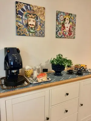 a kitchen counter with a coffee maker on top of it at Stella del Centro Apartment in Palermo