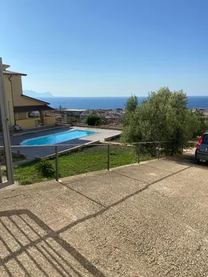 a house with a swimming pool and a fence at Villa Rosa Bella Vista Balestrate in Balestrate