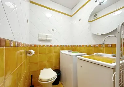 a bathroom with a white toilet and a sink at Solemar Sicilia - Casa Scordia in Palermo