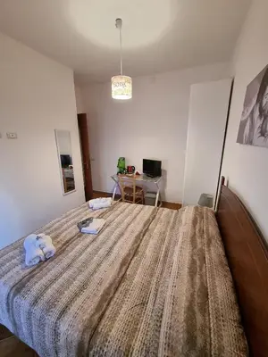 a bedroom with a bed with two towels on it at Le stanze di Aurora in Palermo
